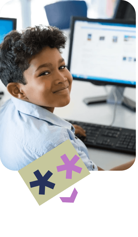 child sitting behind computer